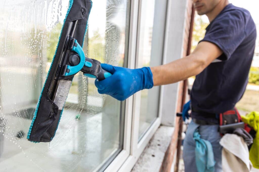 Male professional cleaning windows